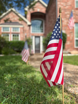 American flags displayed in front of a southern home in honor of the fourth of July. Patriotism concept.