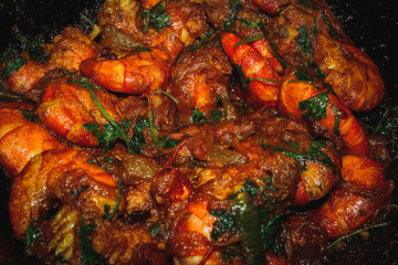 A Delicious and Authentic Bengali and Indian Seafood Dish, Cooked in a Pan with Aromatic Spices and Herbs, Representing Traditional Regional Cuisine