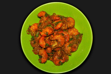 A Delicious and Traditional Bengali and Indian Seafood Dish on a Green Plate, Set Against a Dark Background