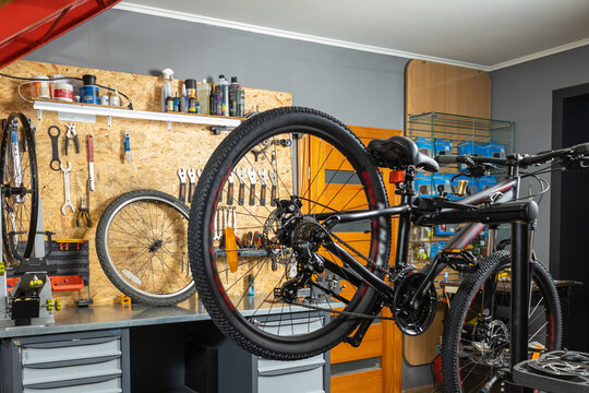 Tool panel with screwdrivers and wrenches, bicycle on stand