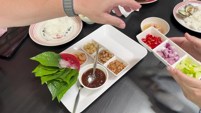 Preparing Miang Kham Savory Leaf Wraps at Dining Table