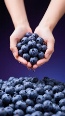 Closeup of fresh blueberries in one hand
