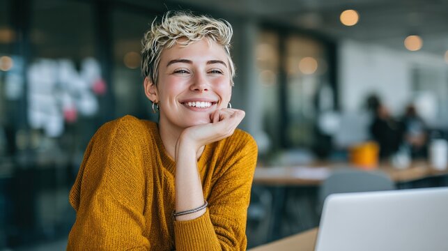 Serene Reflections: A woman with short blond hair sits in an office setting. She smiles gently, with her head resting on her hand, a picture of tranquil contentment and professional composure. 