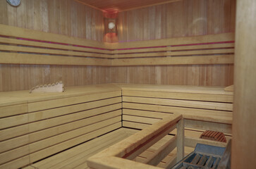 Finnish or dry sauna with oceanview or view of the sea inside male locker room of spa or wellness are onboard luxury cruiseship or cruise ship liner