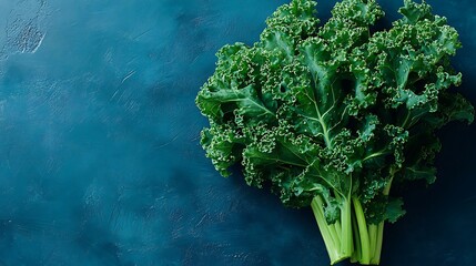 Fresh kale bunch vibrant on deep blue textured backdrop perfect for healthy eating and lifestyle concepts
