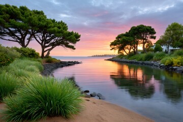 Obraz premium Tranquil coastal inlet reflecting vibrant sunrise sky at dawn