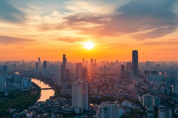 Fototapeta premium Aerial view of a city skyline at sunset. Skyscrapers, river, and colorful clouds are prominent