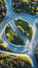 Aerial view of a complex highway roundabout, surrounded by trees and greenery