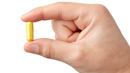 Yellow capsule isolated on transparent background held on hand with fingers