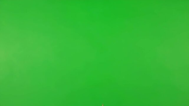 Falling Leaf on Green Screen - A single, dead leaf gracefully falls against a bright green screen background. This high-definition footage is ideal for compositing and visual effects.