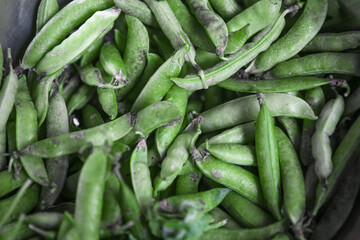 Green peas in bowls on a wooden table. Preparing green peas at home