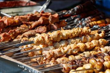 A variety of meats and vegetables are skewered and ready to be cooked