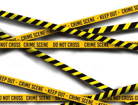 police line crime scene tape and do not cross tape over dark bricks wall.