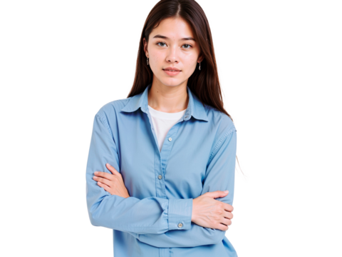A young woman stands confidently with her arms crossed, wearing a light blue shirt. She has long hair and an expressive look, set against a simple background.