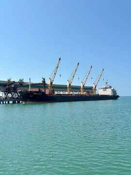 Russia, Tuapse, July 14, 2025: Oil tanker ship loading in port in the harbor of the Tuapse town. Cargo oil tanker is in the port for loading. Transportation of oil and oil products by sea.