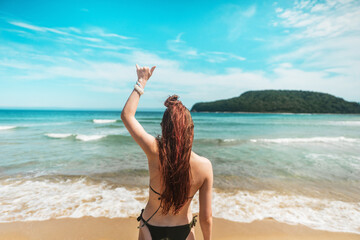 Female silhouette by sea expresses freedom and calm. Ocean breeze, soft waves, and scenic island create feeling of peace, balance, and escape from everyday life into natural beauty.