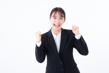 ガッツポーズするスーツを着た若い女性