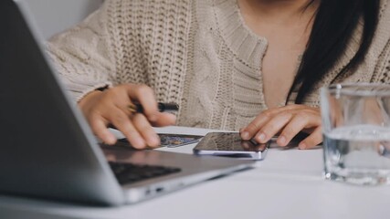Close up Male hands holding credit card and smartphone, man paying online, credit card shopping, using banking service, entering information, shopping, ordering in internet store, doing secure payment - Powered by Adobe
