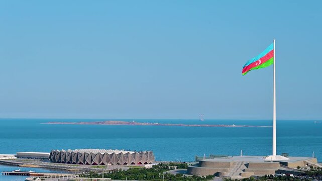 Flag waving over State Flag Square with the Caspian Sea in the background in Baku, Azerbaijan