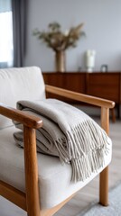 Close-up of a merino wool throw on a chair in a serene living space, ideal for adding text. 