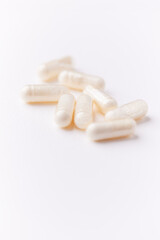 Creatine tablets on paper background. Soft focus. Close up. Copy space.	