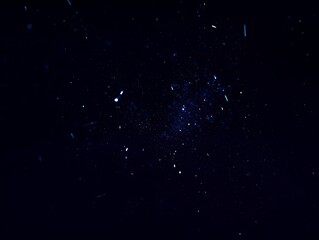 Fototapeta premium Cosmic Dust Particles Floating Through the Deep Dark Space with Bright Stars