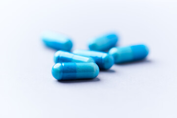 Amino acids capsules on bright background. Soft focus. Close up. Copy space.	