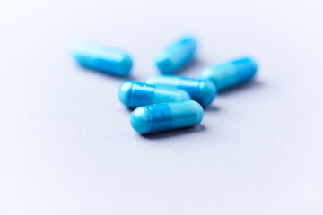 Amino acids capsules on bright background. Soft focus. Close up. Copy space.	