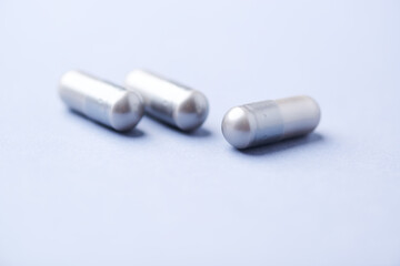 Amino acids capsules on bright background. Soft focus. Close up. Copy space.	