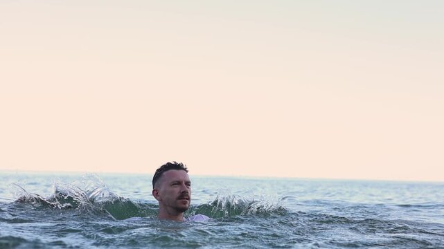 Young man enjoying swimming in the sea