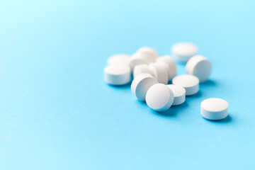 Hyaluronic acid tablets. Hyaluronic acid helps skin stretch and flex and reduces skin wrinkles. Bright paper background. Soft focus. Close up. Copy space	