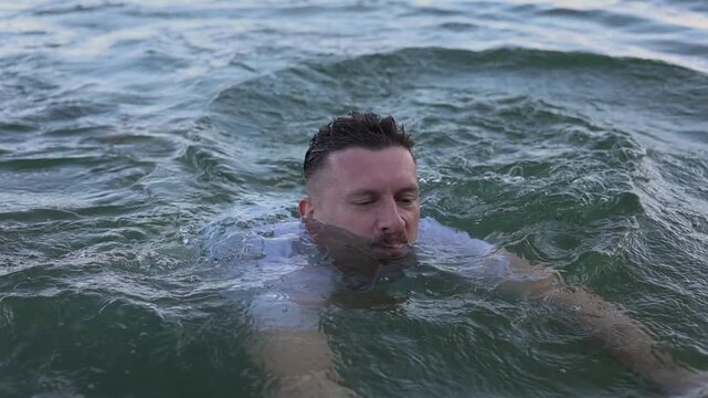 Young man enjoying swimming in the sea