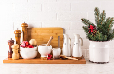 Wooden Mill Set With Spices, Ceramic Oil Bottles On Wooden Stand With New Year And Christmas Decorations. Front view. The concept of New Year's decor