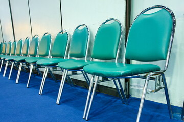 Row of Empty Turquoise and Chrome Chairs in Auditorium – Conference Seating, Seminar Venue,...
