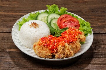 Ayam geprek is a typical Indonesian fried chicken dish with flour that is mashed or mashed with plow chili sauce