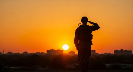 A lone soldier's silhouette is captured in a respectful salute against a fiery orange and yellow sunset a striking image of military duty and devotion to country