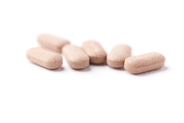 Ashwagandha (Withania somnifera) tablets on paper background. Soft focus. Close up. Copy space.	