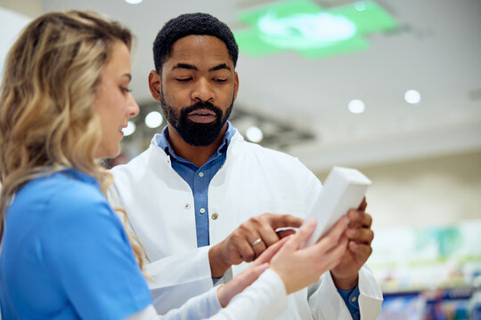 Healthcare Professionals Reviewing Medication Instructions at a Pharmacy Counter