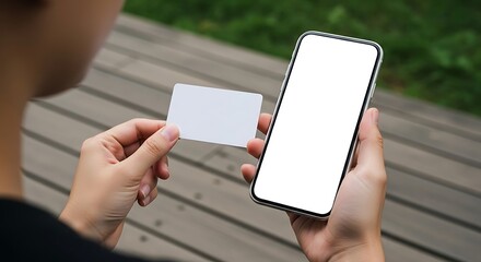 Person holding a smartphone and a blank white business card, mockup for app or branding