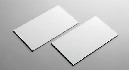 Two blank white business cards on a plain gray background, mockup for branding