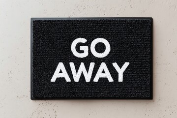 Door mat with bold message inviting guests to not disturb at home entrance