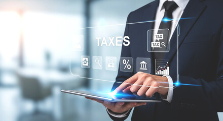 Man in suit using tablet with taxes icons and graphs overlayed in a modern office environment setting