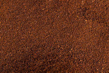 ground coffee for preparation of a drink, closeup, roasted ground coffee in large quantities