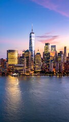 Fototapeta premium City skyline at dusk, reflecting on calm water