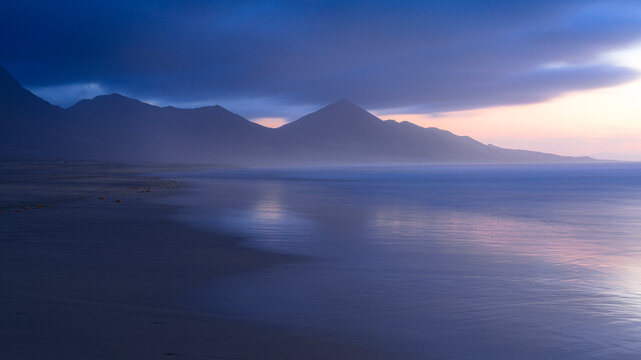 Waves crashing on Cofete beach at dusk, Fuerteventura