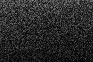 Textured black surface with rough pattern and matte finish