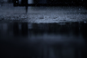 heavy raining make many small splash crown from water droplets drop down to the concrete floor in...