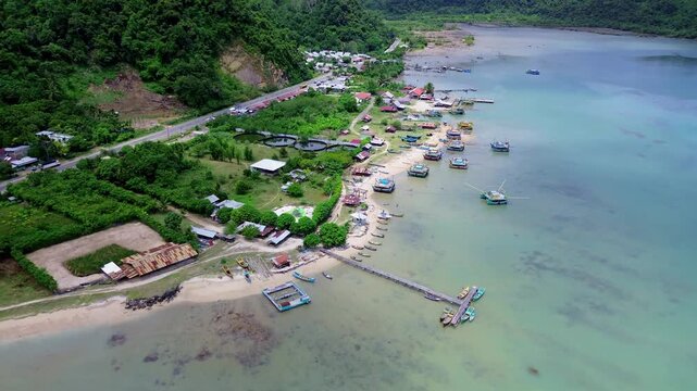 Aerial View of Fishing Port beside Road and Mountain Backdrop in Lhokseudu, Aceh, Indonesia