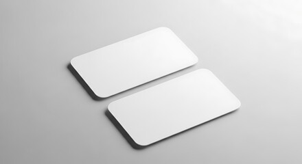 Two blank white business cards with rounded corners, isolated on a light background