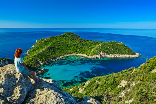 Woman enjoying scenic view above Porto Timoni Corfu Greece coast